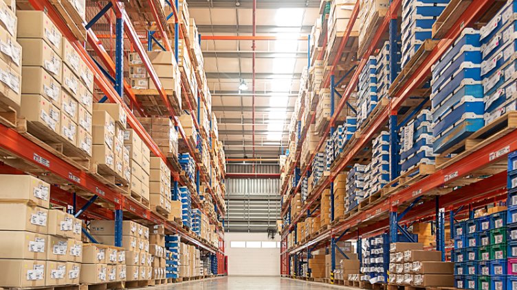 View of an industrial warehouse with neatly stacked boxes on pallet racks